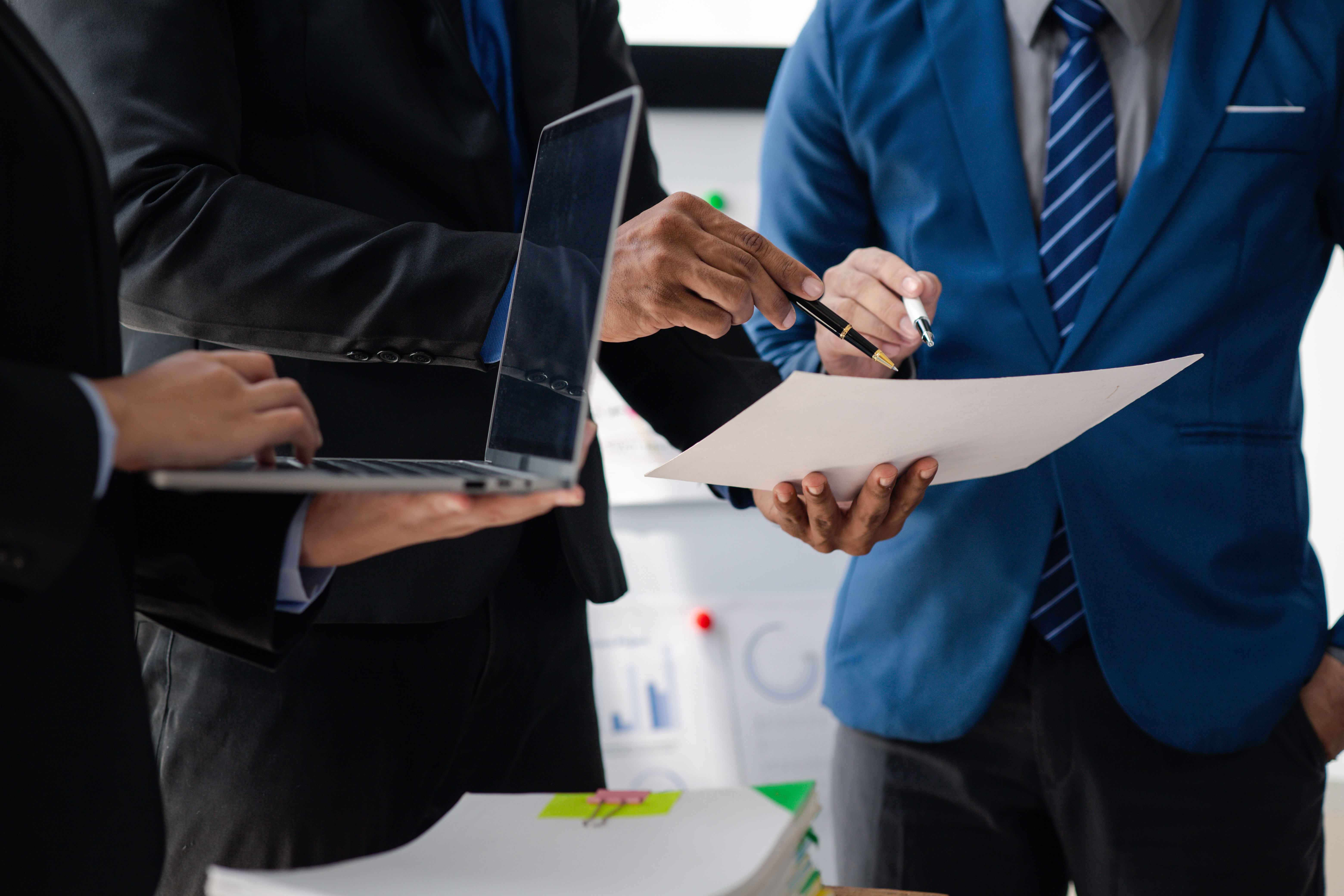 Businessman is reviewing monthly sales documents for analysis and marketing plans for more sales gro